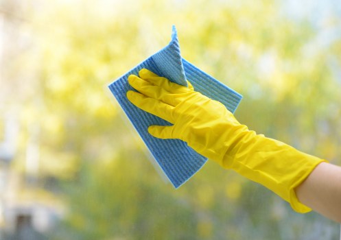 Cleaning professional using safe procedures in a tidy workspace