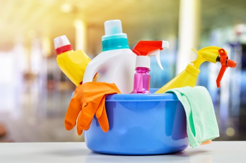 Team member handling cleaning products with protective equipment