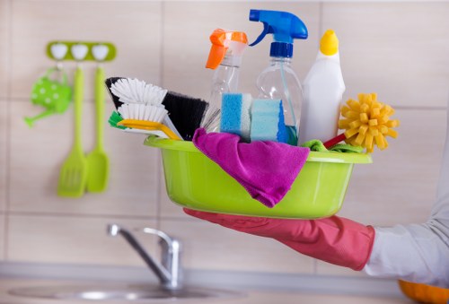 Staff member wearing PPE while cleaning with attention to safety standards